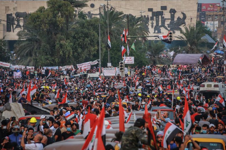 Blocking police at checkpoints, Iraqis revel in people power