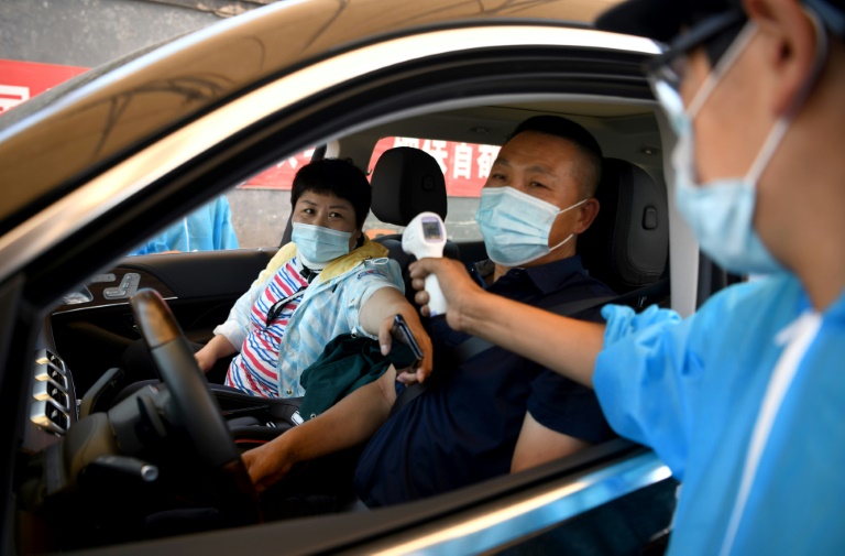 Beijing locks areas down as new virus outbreak gathers pace