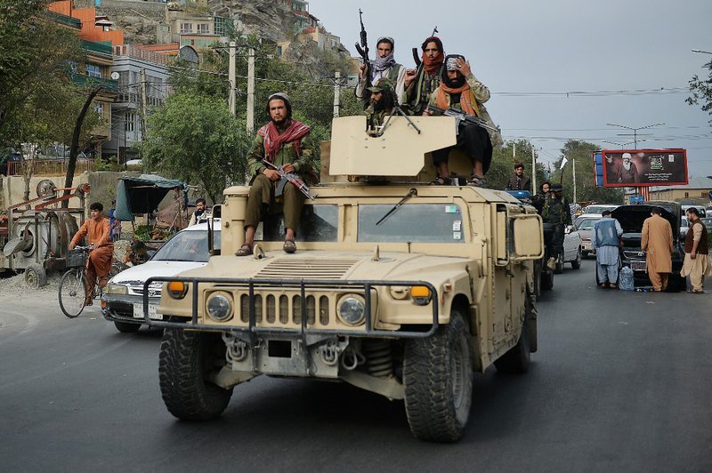 Taliban parade as Biden defends US pullout